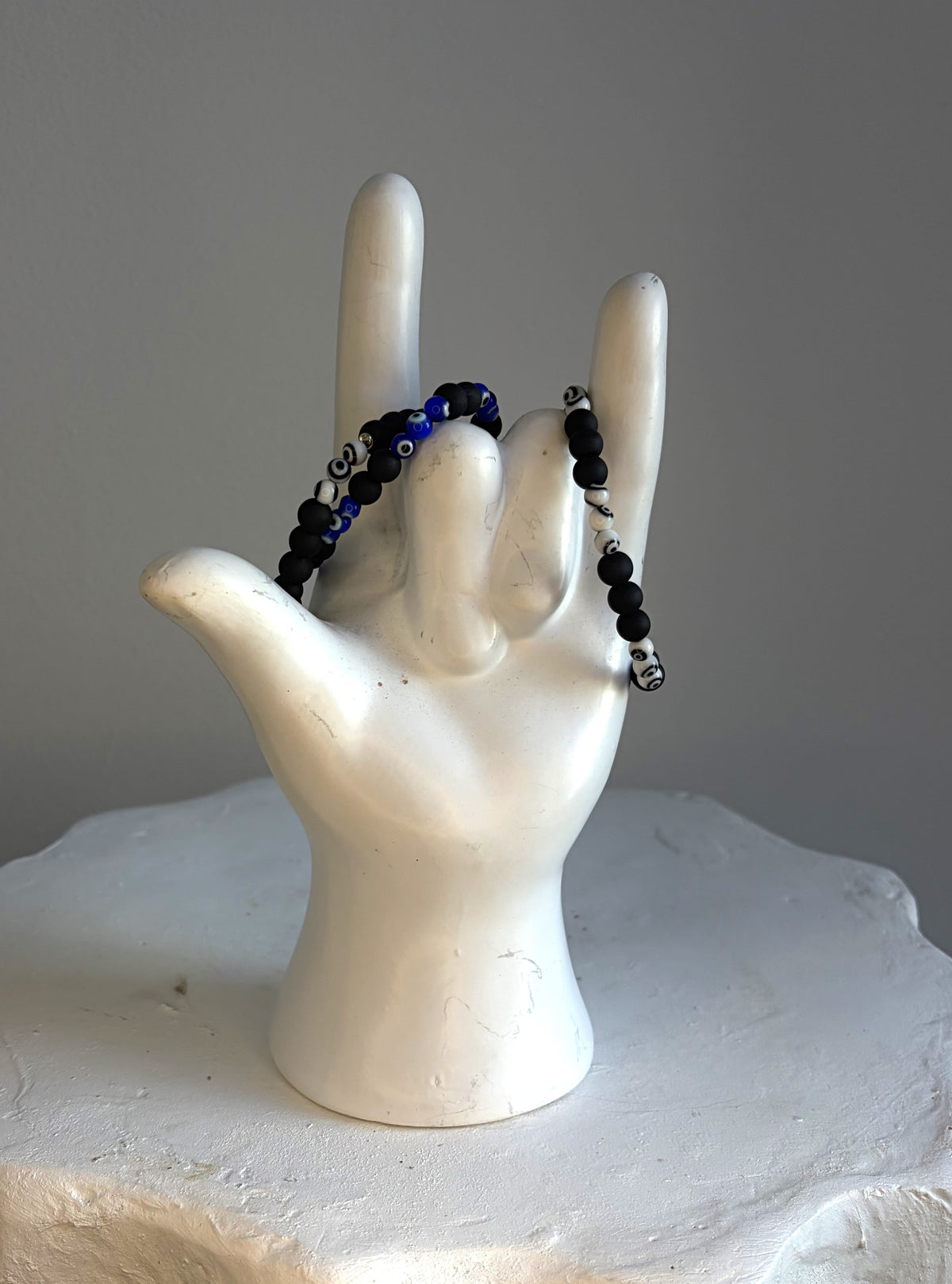 Matte black beaded bracelet with blue-and-white glass evil eye beads