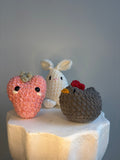 Hand-crocheted strawberry, bunny, and hen