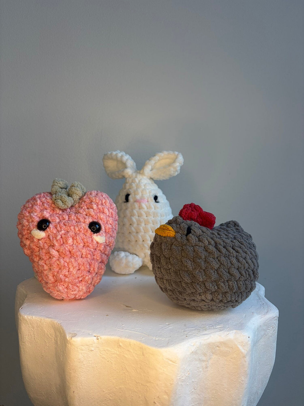 Hand-crocheted strawberry, bunny, and hen